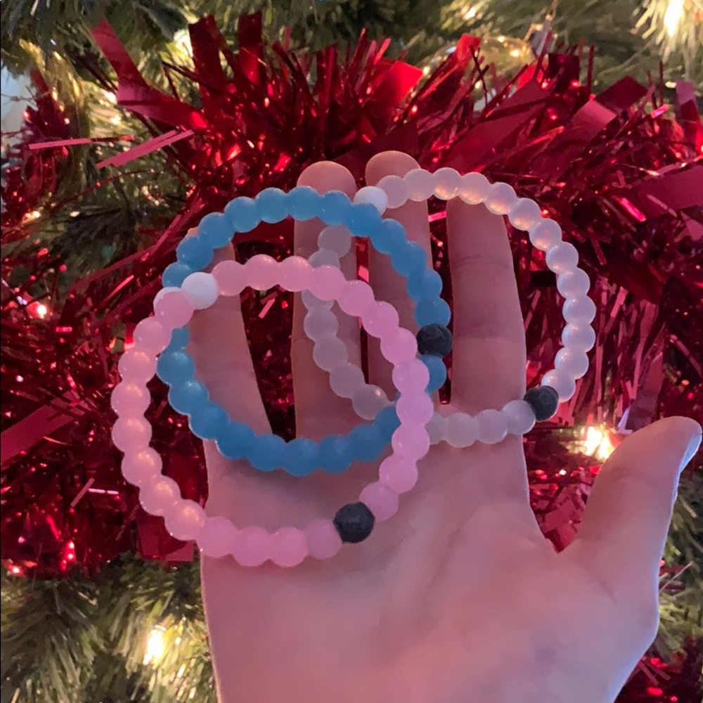 Pink , white and blue Lokai bracelets